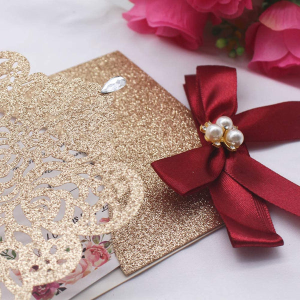 Gold Glitter Laser Cut Invitations with Deep Red Ribbon and Diamond Brooch