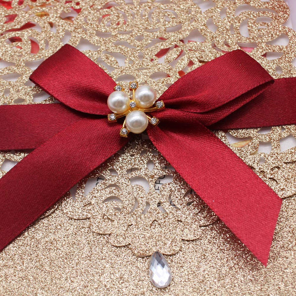 Gold Glitter Laser Cut Invitations with Deep Red Ribbon and Diamond Brooch